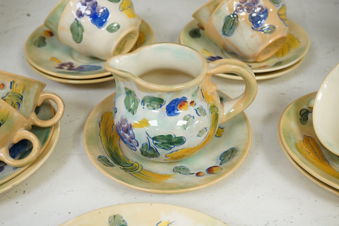 A collection of Doulton Brangwynware to include cups and saucers and a milk jug, largest 19cm in diameter
